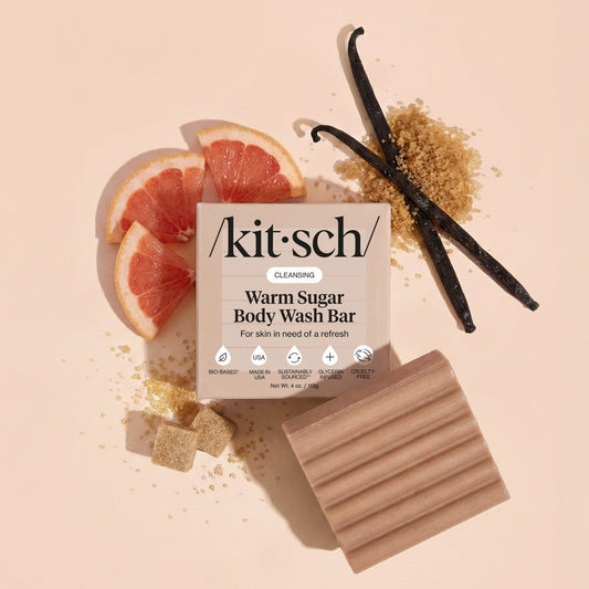 KITSCH Cleansing Warm Sugar Body Wash Bar — lifestyle product shot with vanilla and grapefruit props — Infused with decadent notes of warm vanilla, spun sugar, and pink grapefruit — leaves skin wrapped with a sweet gourmand scent